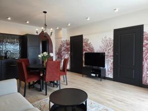 a living room with a table and a tv at Apartamenty Stargardt in Stargard