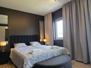 a bedroom with a bed with two towels on it at Apartamenty Stargardt in Stargard