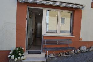 a bench in front of a door of a house at Am Burg in Klotten