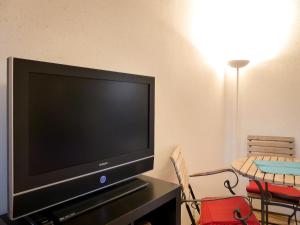 a flat screen tv sitting on top of a table at Appartement an der Seefelder Mühle in Seefeld