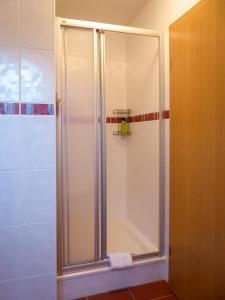 a shower with a glass door in a bathroom at Appartement an der Seefelder Mühle in Seefeld +18 photos
