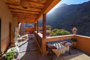 a balcony of a house with a view of a mountain at Eagle Lodge in Imlil