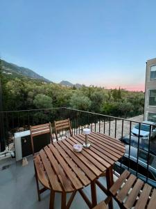 a wooden table and two chairs on a balcony at Drymades Studio Apartment in Gjilek