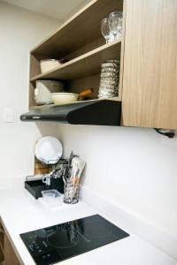 a kitchen counter with a sink in a kitchen at Althea's Horizon Stay - Primeworld District in Pajak