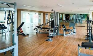 a gym with treadmills and exercise equipment in a building at Althea's Horizon Stay - Primeworld District in Pajak