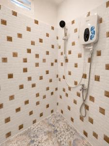 a bathroom with a shower with a shower head at Ah Gong Boutique Bungalows in Sihanoukville