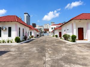 a row of houses with red roofs on a street at Ah Gong Boutique Bungalows in Sihanoukville
