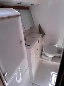 a small white bathroom with a toilet in it at BeliBoat in Cascais