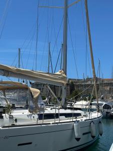 a sailboat docked at a dock in a harbor at BeliBoat in Cascais