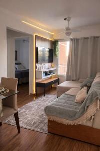 a bedroom with a bed and a living room with a table at Spazio Dela vita in Sorocaba