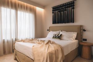 a bedroom with a bed and a large window at Ora Blu Villas in Mytikas +52 photos