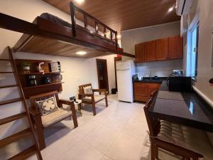 a kitchen with a loft bed and a living room at Condomínio Feitosa Barros I in Maceió