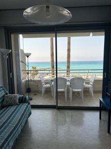 a bedroom with a view of the ocean with a table and chairs at Casa Lea in Ventimiglia