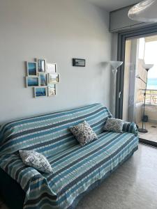 a blue couch with pillows in a living room at Casa Lea in Ventimiglia