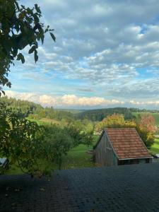 an old barn sitting on top of a field at Gemütliches Doppelzimmer mit Balkon und Saunaoption Nordschwarzwald in Simmersfeld