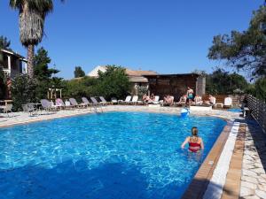 a woman in the water in a swimming pool at Value Double Lower – Room 12 in Gouvia