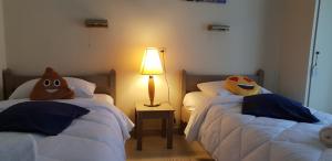 a bedroom with two beds with faces on them at 2BR Family Gouvia – Apt 2 in Gouvia