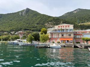 a group of buildings next to a body of water at La terrazza Iseana in Predore