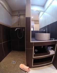 a bathroom with a sink and a shower at Hotel Le Mas Saint Joseph in Saint-Rémy-de-Provence