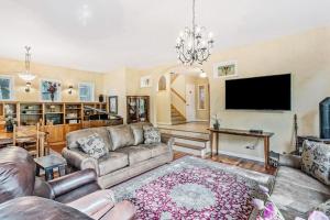a living room with a couch and a flat screen tv at Steamboat Villa in Steamboat Springs