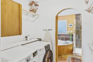a laundry room with a washing machine and a tub at Steamboat Villa in Steamboat Springs +33 photos