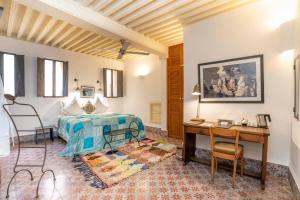 a bedroom with a bed and a desk and a desk at Riad Laaroussa in Fez