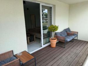 a balcony with two chairs and a table and a couch at Apartament 8 in Łobez