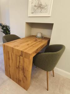 a wooden table with two chairs in a room at Saint Patricks Wicklow in Wicklow