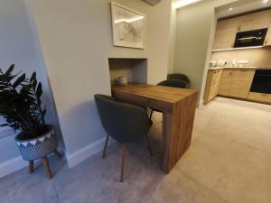 a kitchen with a wooden table and chairs and a plant at Saint Patricks Wicklow in Wicklow