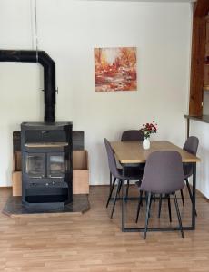 a living room with a table and a wood stove at Apartments MLIN in Bihać