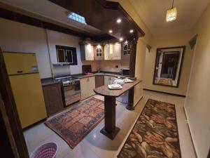 a kitchen with a table in the middle of it at Alex dream in Alexandria