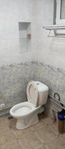 a bathroom with a toilet with the seat up at Памирский дом in Khorog