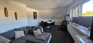 a living room with a couch and a table at Ferienwohnung in Brunsbüttel mit E-Bike Verleih in Brunsbüttel