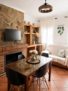 a living room with a table and a fireplace at Los Meri in Grazalema
