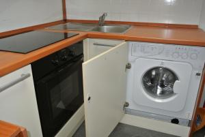 a kitchen with a washing machine and a sink at Casa Selly in Loano