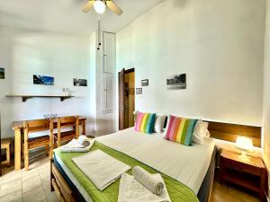 a bedroom with a bed and a dining room at Fetsis Apartments in Agios Nikitas