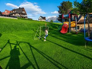 a young child is playing on a playground at Domek u Justyny in Kościelisko