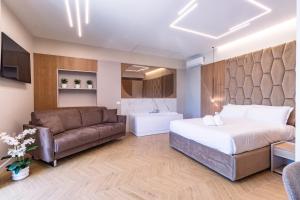 a hotel room with a bed and a couch at Live in Gaeta in Gaeta