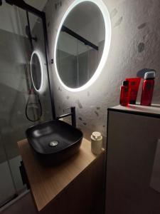 a bathroom with a black sink and a mirror at Apartman NoTi in Milna +28 photos