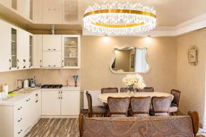 a kitchen and dining room with a table and a chandelier at Villa Arsha in Arsha