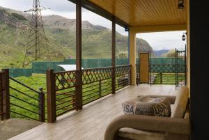 a room with a balcony with a view of mountains at Villa Arsha in Arsha