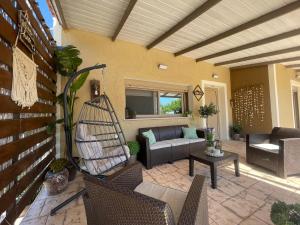 a patio with a couch and chairs and a table at Villeta Nikol in Lixouri