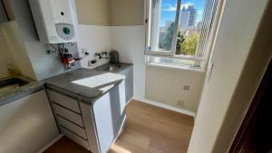 a small kitchen with a sink and a window at Vcp urban suites in Villa Carlos Paz