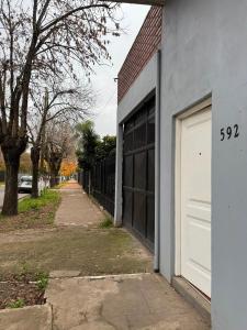 a building with a garage door and a street at Departamento cercano al centro de Ezeiza in Ezeiza
