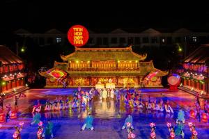 a group of people dancing in front of a building at night at Olivea Boutique Hotel Phu Quoc in Phú Quốc
