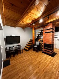 a large living room with a fireplace and stairs at Rumelówka in Wawrowice