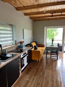 a kitchen and living room with a couch and a table at Rumelówka in Wawrowice