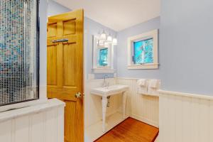 a white bathroom with a sink and a window at Rescue Lake in Ludlow +40 photos