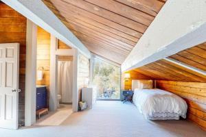 a bedroom with a wooden ceiling with a bed in it at Gore Creek Haven in Vail