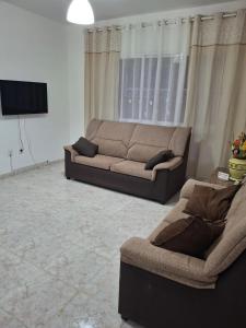 a living room with a couch and a tv at Casa Rosi in Gran Tarajal